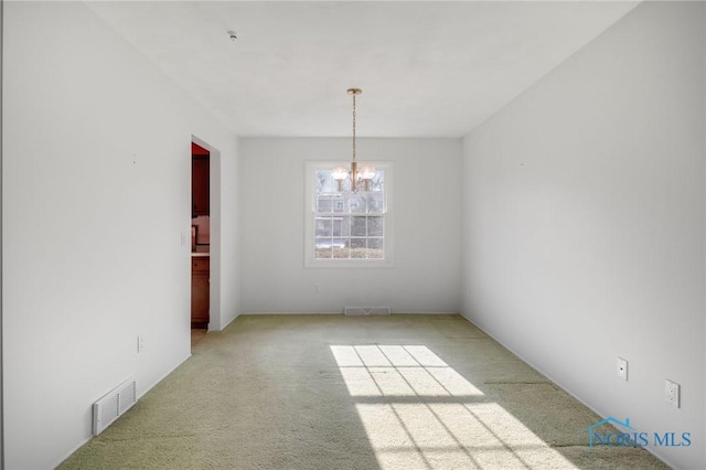 unfurnished dining area with light carpet and a chandelier