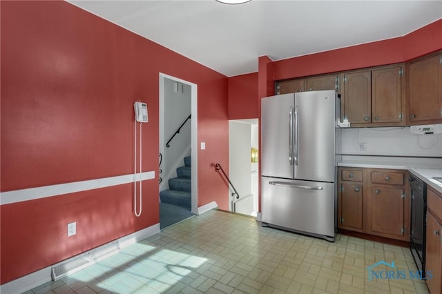 kitchen featuring black dishwasher and stainless steel fridge