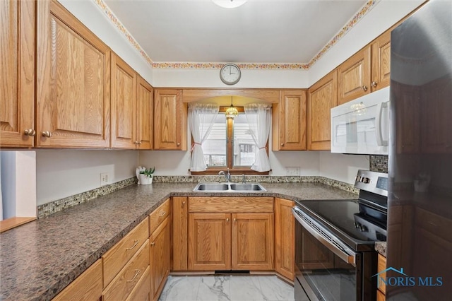 kitchen featuring stainless steel range with electric stovetop and sink