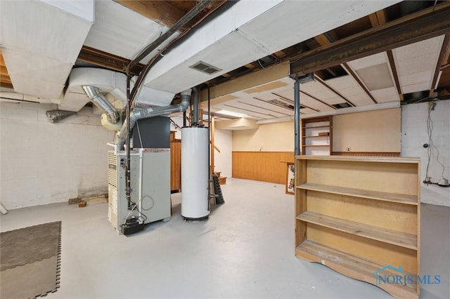 basement featuring water heater and heating unit