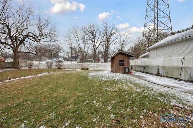 snowy yard featuring a storage shed