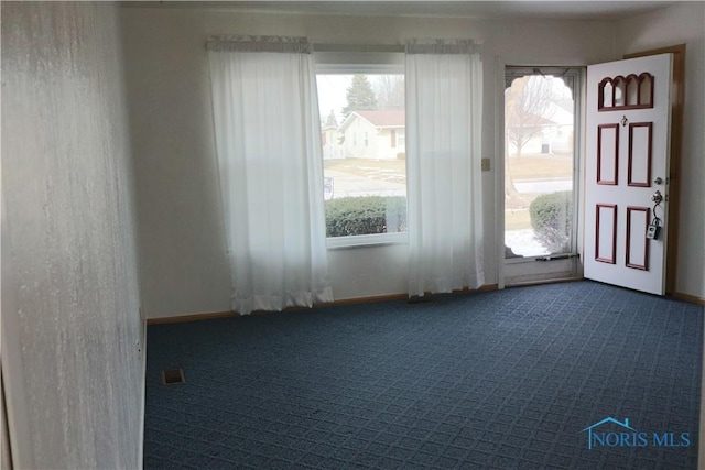 interior space featuring dark colored carpet