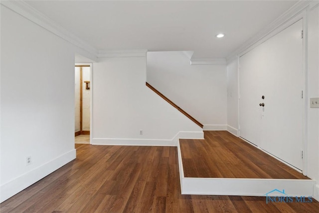 foyer entrance with crown molding and hardwood / wood-style flooring