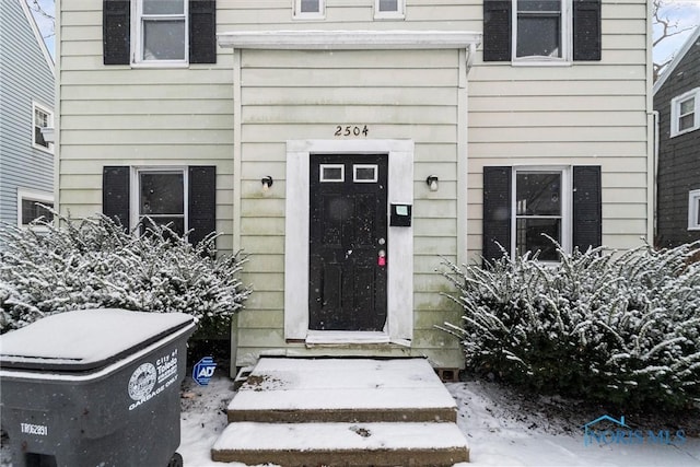 view of snow covered property entrance