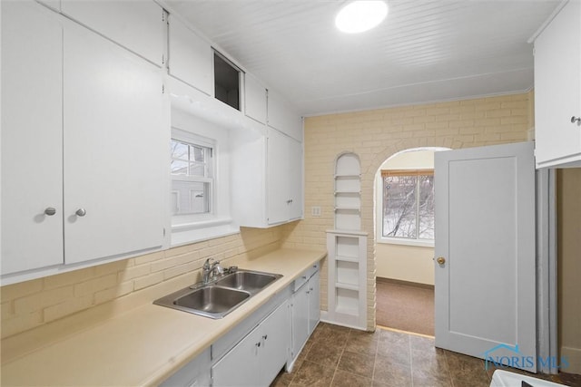 kitchen with sink, white cabinetry, and tasteful backsplash