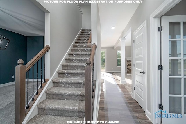 staircase with ornate columns