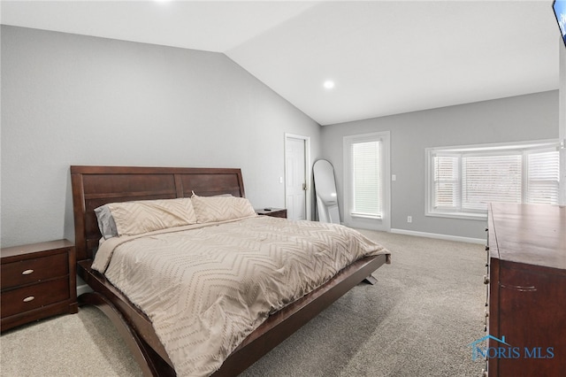 carpeted bedroom with vaulted ceiling