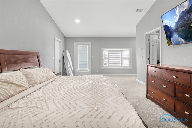 bedroom with lofted ceiling and light colored carpet