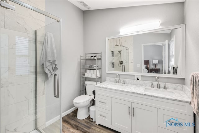 bathroom with walk in shower, vanity, toilet, and hardwood / wood-style flooring