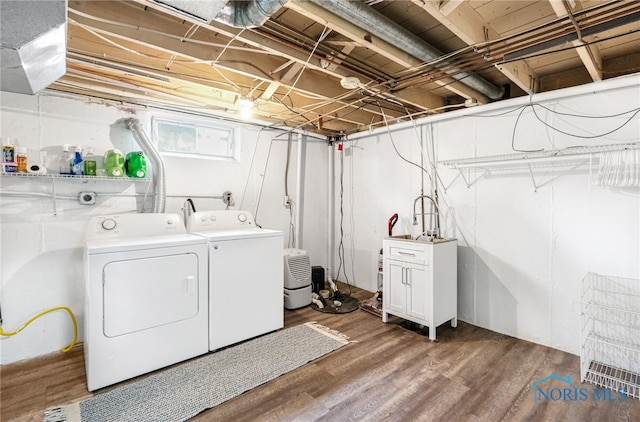 clothes washing area with independent washer and dryer and hardwood / wood-style floors