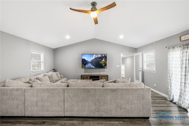 living room featuring ceiling fan, dark hardwood / wood-style flooring, lofted ceiling, and a wealth of natural light