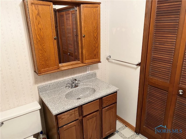 bathroom with toilet and vanity