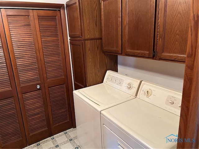 laundry area featuring cabinets and washer and clothes dryer