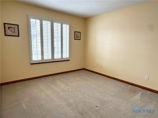 empty room featuring light carpet