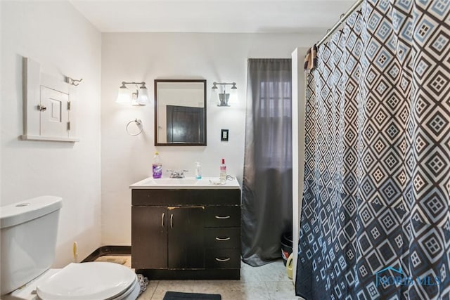 bathroom with toilet, vanity, and a shower with shower curtain