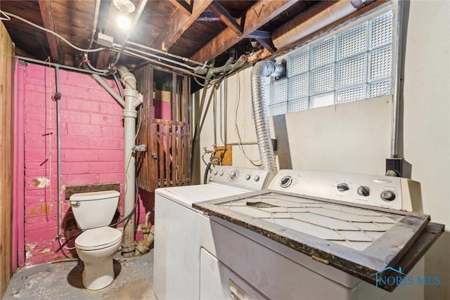 clothes washing area with washer and clothes dryer