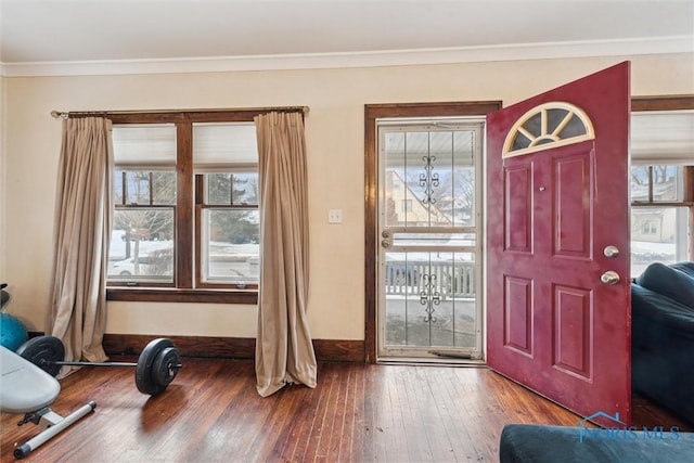 entrance foyer with hardwood / wood-style flooring and crown molding