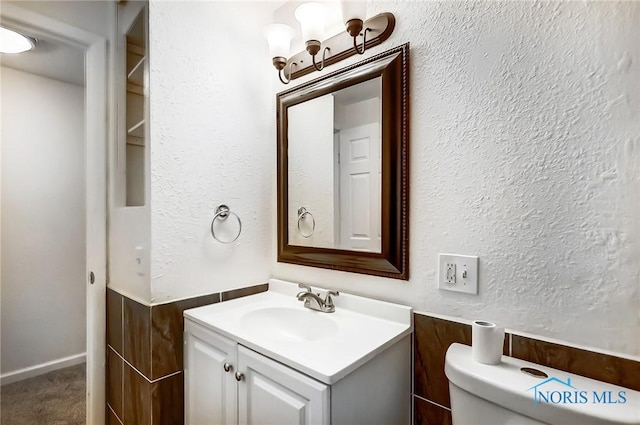 bathroom featuring toilet and vanity