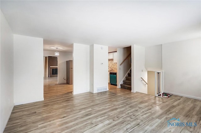 unfurnished living room with light wood-type flooring