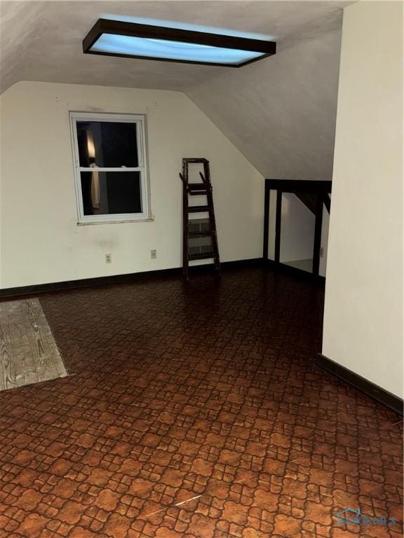 spare room featuring vaulted ceiling