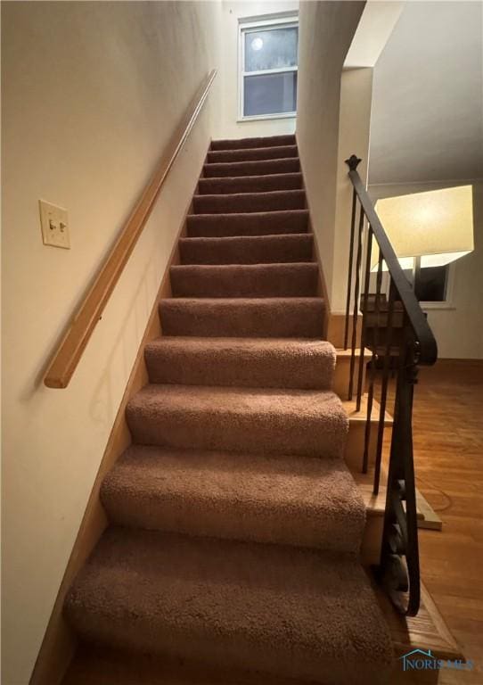 stairway featuring hardwood / wood-style flooring