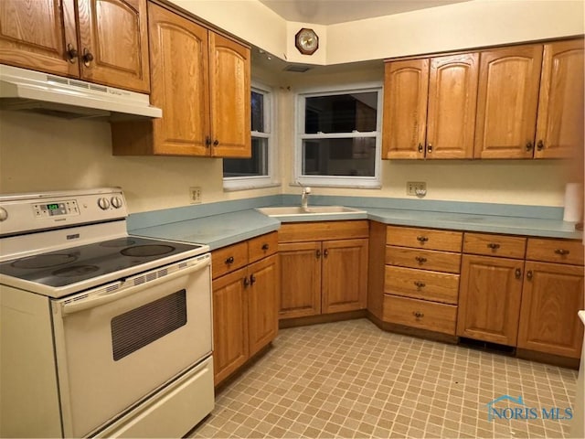 kitchen with white range with electric cooktop and sink