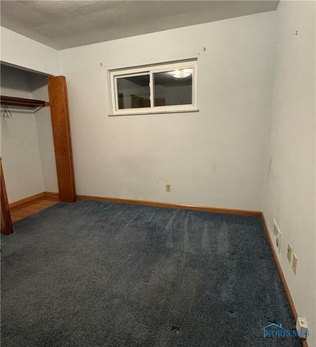 unfurnished bedroom with carpet floors and a closet