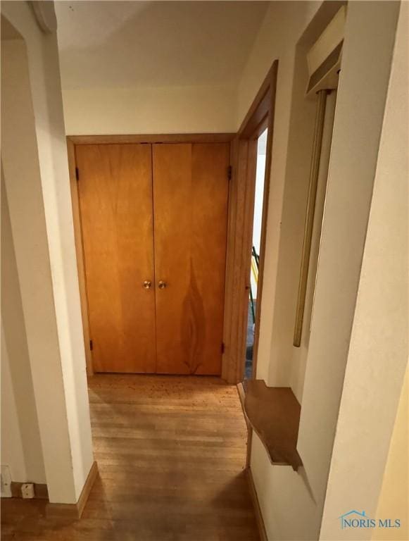 hallway with light hardwood / wood-style flooring