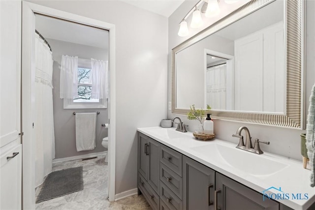 bathroom featuring toilet and vanity