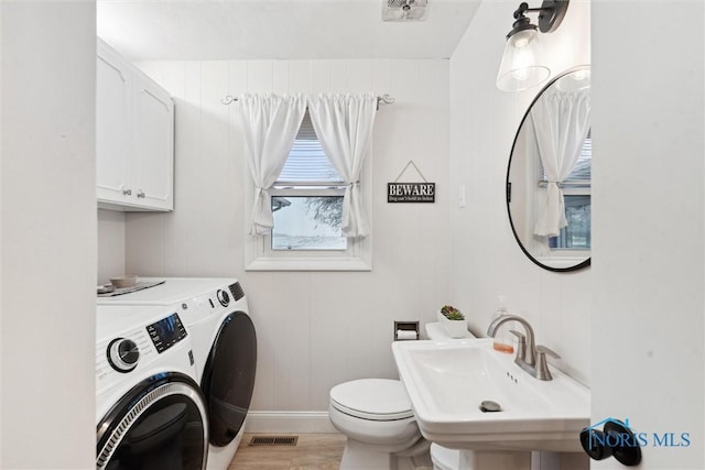 laundry area featuring light wood-type flooring and sink