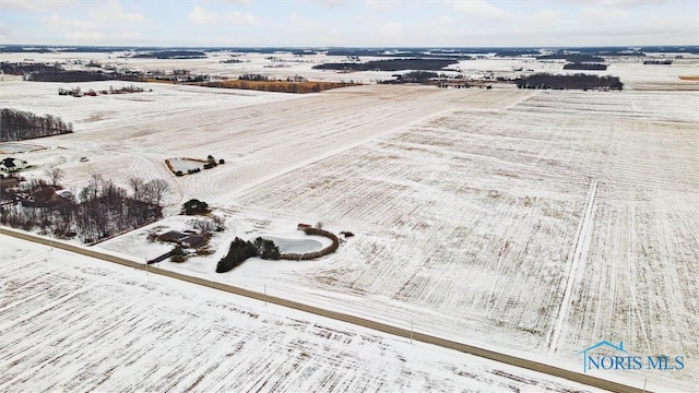 snowy aerial view featuring a rural view