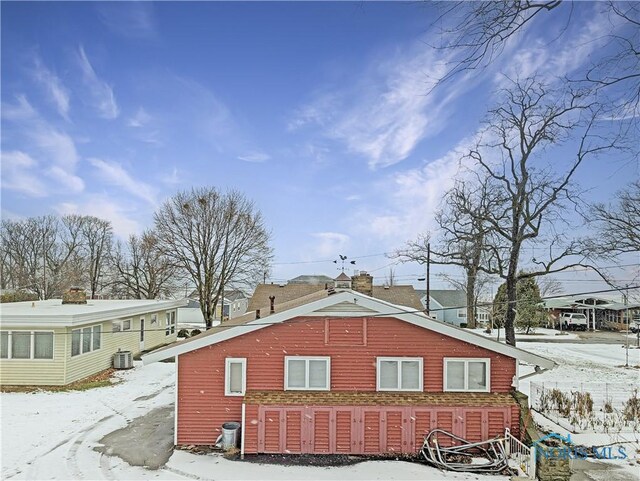 1318 E 4th St, Marblehead, OH 43440 - snow covered property with central AC
