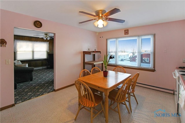 1318 E 4th St, Marblehead, OH 43440 - dining space featuring baseboards, a ceiling fan, light floors, and baseboard heating