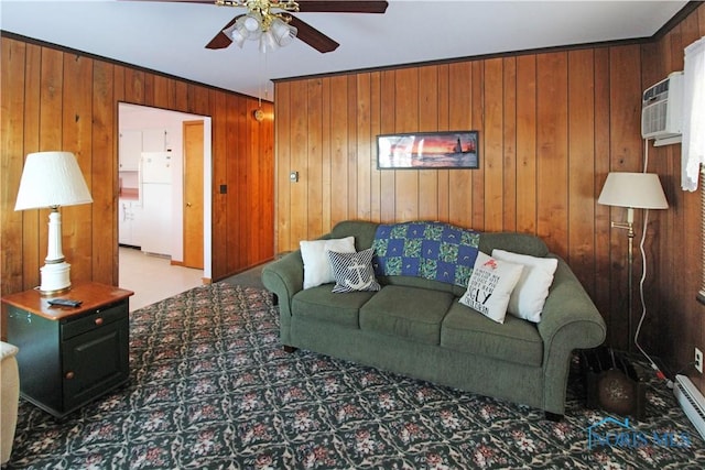 1318 E 4th St, Marblehead, OH 43440 - living area featuring ceiling fan, a wall unit AC, a baseboard radiator, wooden walls, and carpet