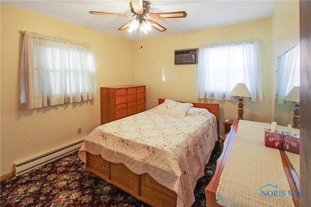 1318 E 4th St, Marblehead, OH 43440 - bedroom featuring multiple windows, a wall unit AC, a baseboard heating unit, and ceiling fan