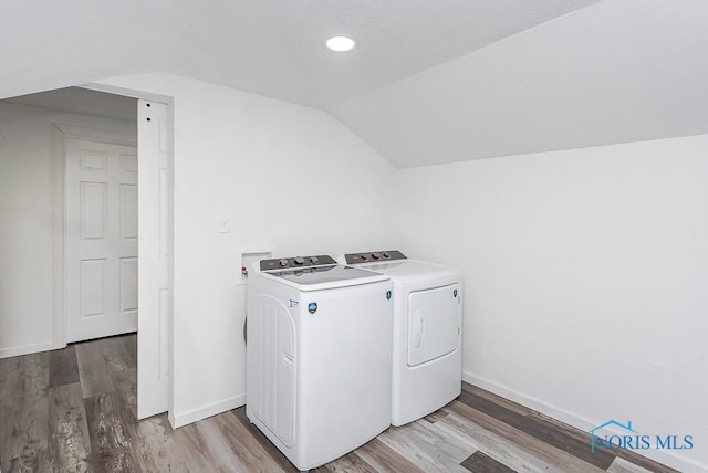 washroom with washing machine and dryer and wood-type flooring