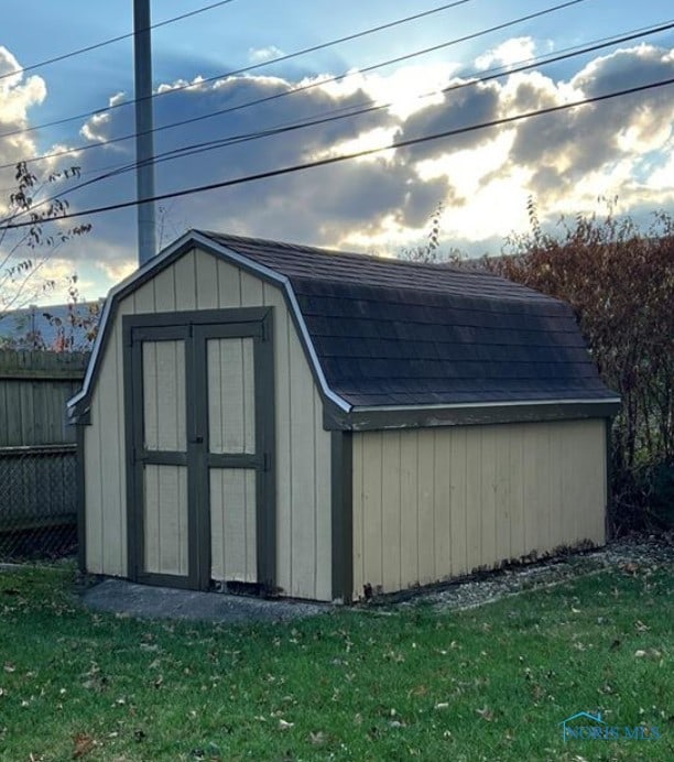 view of outbuilding with a lawn