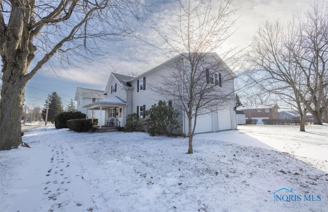 view of snow covered exterior featuring a garage