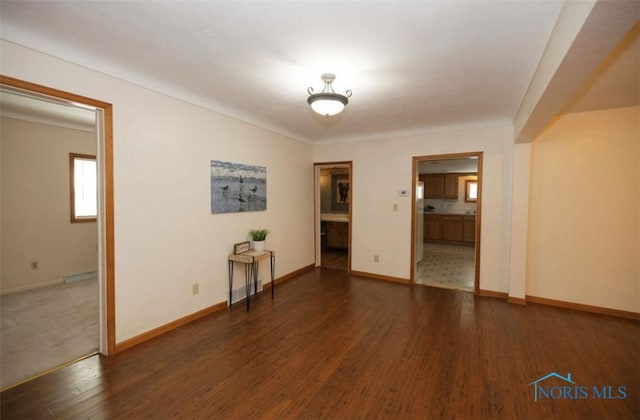 spare room featuring dark hardwood / wood-style flooring