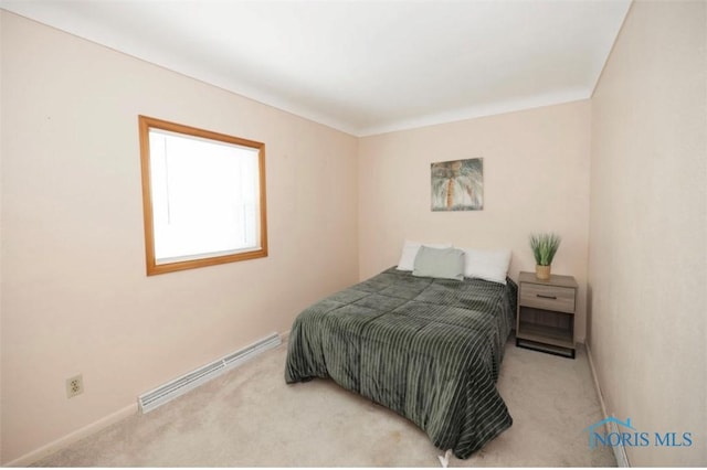 carpeted bedroom featuring a baseboard radiator