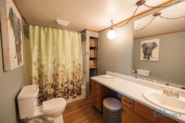 full bathroom featuring shower / tub combo with curtain, toilet, vanity, ornamental molding, and hardwood / wood-style flooring