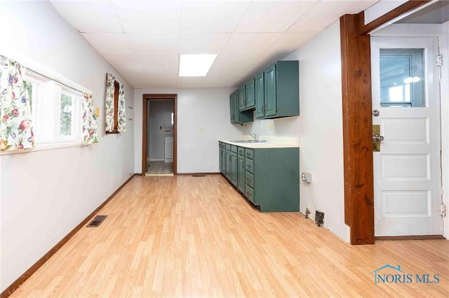 kitchen with light hardwood / wood-style flooring and sink