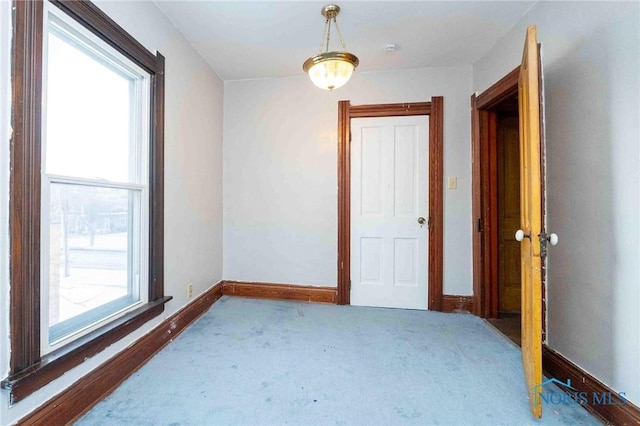 carpeted spare room with a healthy amount of sunlight