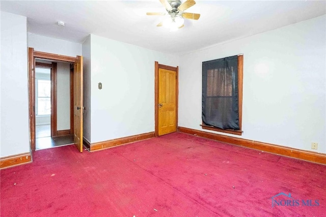 empty room featuring ceiling fan and carpet flooring