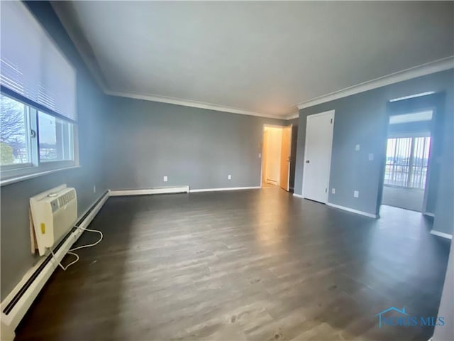 unfurnished room with wood-type flooring, a wealth of natural light, a baseboard heating unit, and ornamental molding