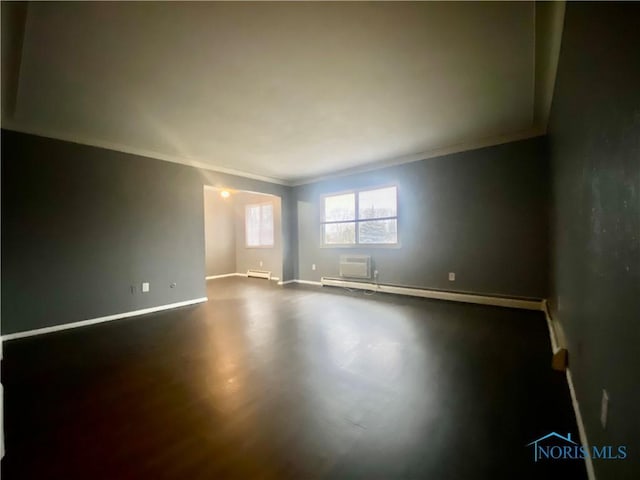 spare room featuring crown molding and a baseboard radiator