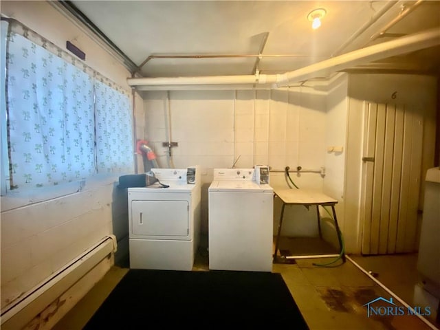 clothes washing area with washer and dryer and a baseboard radiator