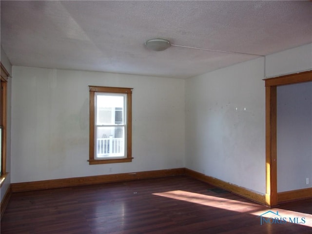 unfurnished room featuring dark wood-type flooring