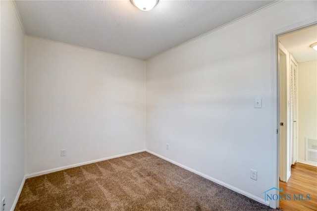 spare room featuring carpet floors and ornamental molding