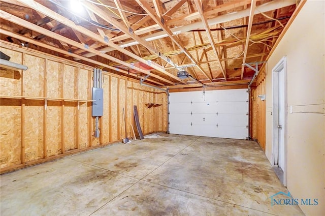 garage with electric panel and a garage door opener